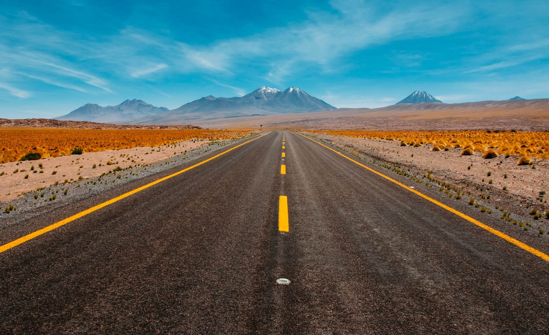 Ungraded desert road footage — flat, hazy, low contrast