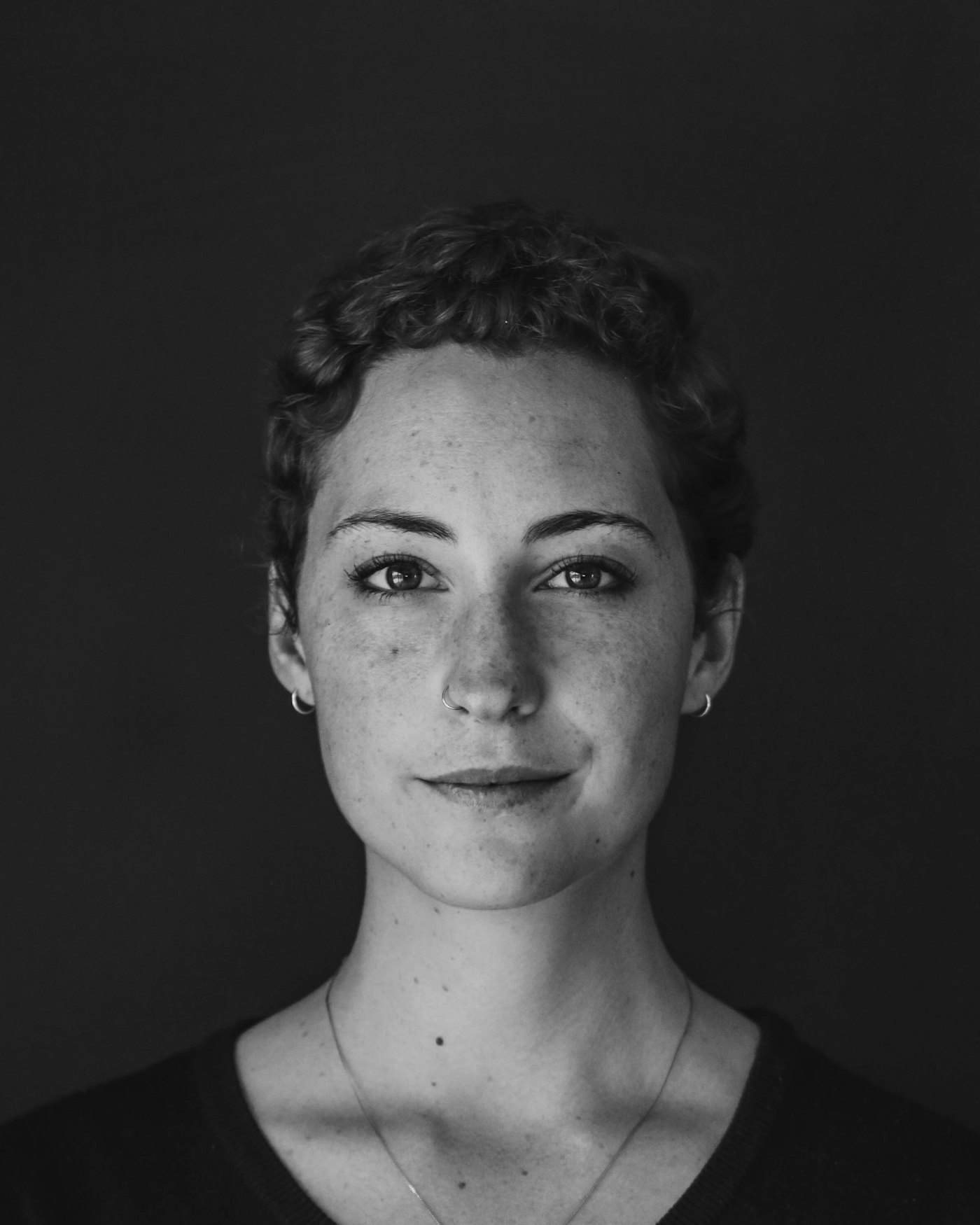Low-key studio portrait lit from a single side source
